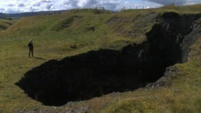 Landowner standing next to sink-hole