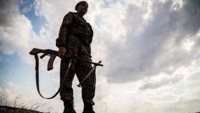 A Ukrainian serviceman walks on the frontline not far from the eastern Ukrainian city of Debaltseve, Donetsk region on August 25