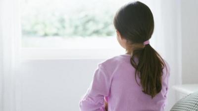 Girl facing window