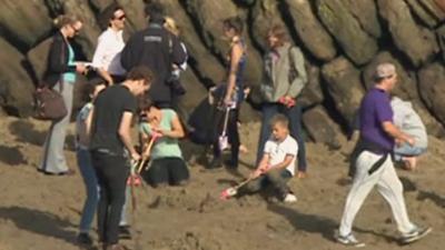 People digging for gold on Folkestone beach