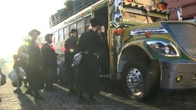 Members of Lev Tahor boarding bus