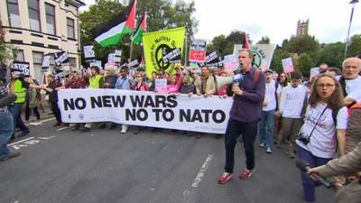 anti nato protestors march through Newport