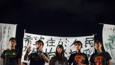 Activists speak at a protest following the ruling