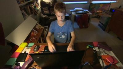 A boy on a computer