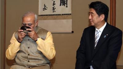 India's Prime Minister Narendra Modi enjoys a cup of green tea next to Japan's Prime Minister Shinzo Abe during a tea ceremony at the Omotesenke, one of the main schools of Japanese tea ceremony, in Tokyo