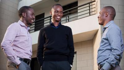 Ayodeji Adewunmi, Olalekan Olude and Opeyemi Awoyemi standing outside in business attire