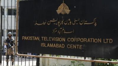 A Pakistani army soldier stands guard outside PTV station