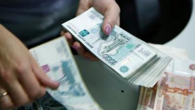 An employee of a bank counts rouble banknotes in Moscow