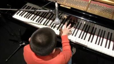Jose Andre Montanho playing piano