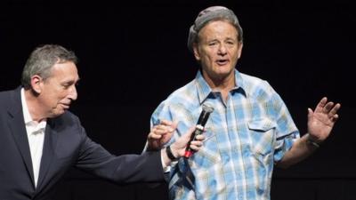 Bill Murray sings to the crowd as producer Ivan Reitman holds a microphone following a screening of the original "Ghostbusters"