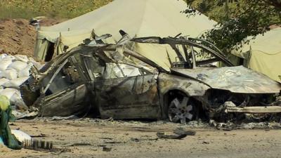 A burnt-out vehicle in Mariupol