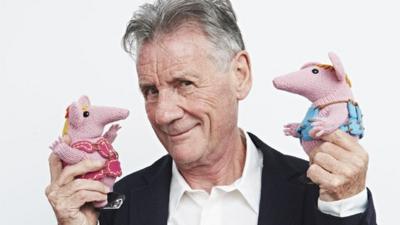 Michael Palin holds two Clanger puppets
