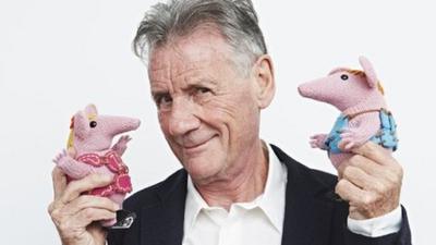 Michael Palin holds two Clanger puppets