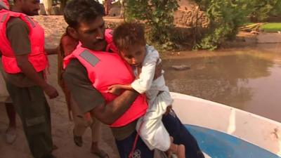 Rescue worker carrying child