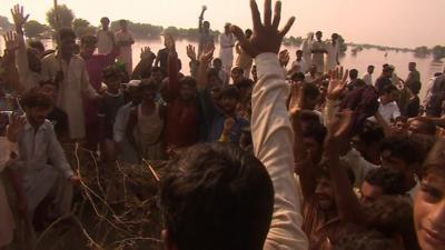 People chanting with arms raised