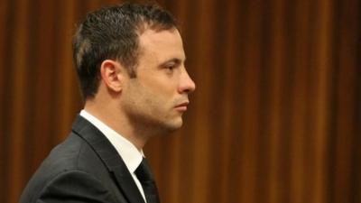 Oscar Pistorius stands in the dock looking straight ahead in court in Pretoria, South Africa, Friday, Sept. 12, 2014