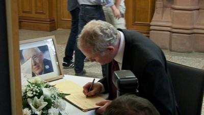 Martin McGuinness signs book of condolence for Mr Paisley at the Guildhall in Londonderry