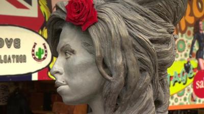 Close up side view of Amy Winehouse statue in Camden