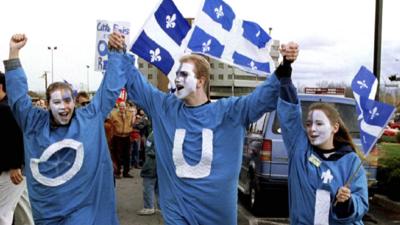 "Yes" supporters, displaying the French word "oui" on their clothes, at a rally in Quebec City, Canada (29 October 1995 file picture)