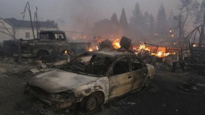 Vehicles and homes are destroyed in Weed, California where a wind-driven wildfire raced through the hillside neighbourhood