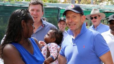 Tony Abbott speaking with an employee during a visit to Dharpa Djarmma Furniture Studio in Gunyangara on the Gove Peninsula, Northern Territory