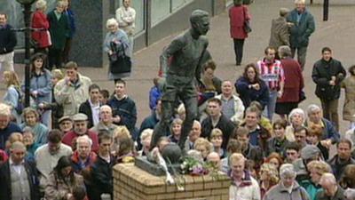 Crowds gathered by the Sir Stanley Matthews statue in Stoke-on-Trent