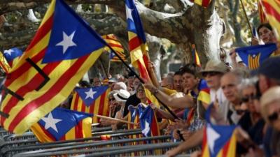 Catalonia separatist supporters wave flags outside parliament