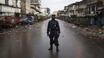 Police officer on deserted street in Freetown