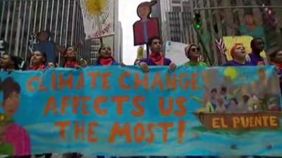 Demonstrators in New York with a banner reading 'Climate change affects us the most'