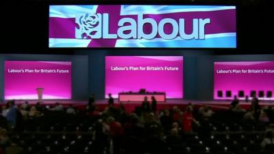 Labour Party conference hall with logo and slogan 'Labour's Plan for Britain's Future'