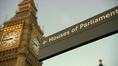 Sign pointing to 'Houses of Parliament' with Big Ben in background