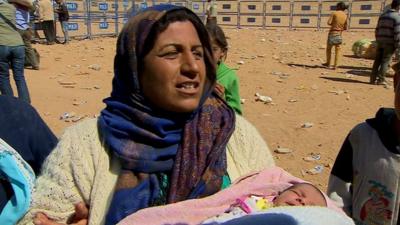 Woman with newborn baby at refugee camp