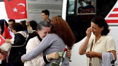 An employee at Turkey's consulate in Mosul is welcomed by her relatives in Ankara on 20 September 2014