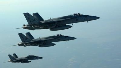 a formation of US Navy F-18E Super Hornets in flight after receiving fuel from a KC-135 Stratotanker over northern Iraq, on September 23 2014