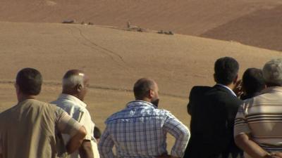 Kurdish villagers overlooking IS militants