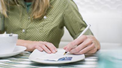 woman signing check