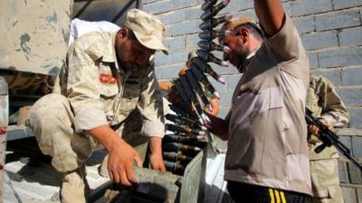 Members of the Iraqi Shiite militia, Asaib Ahl Al-Haq, preparing their ammunition during a battle against Islamic state (IS) in the town of Jurf al-Sakher, south of Baghdad