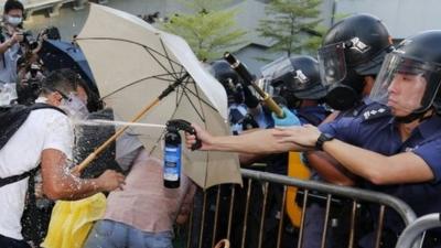 Riot policeman spraying pepper spray