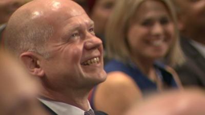 William Hague listens to David Cameron mimicking him