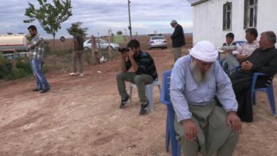 Refugees outside house