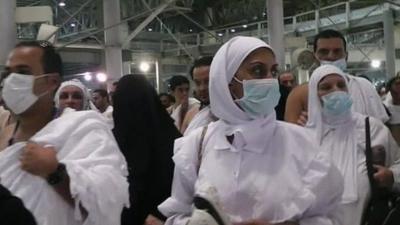 Crowds at the Hajj - some wearing face masks