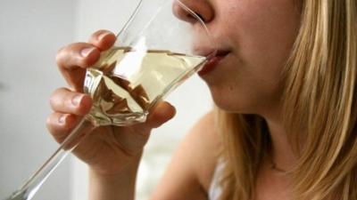 Woman drinking a glass of wine a