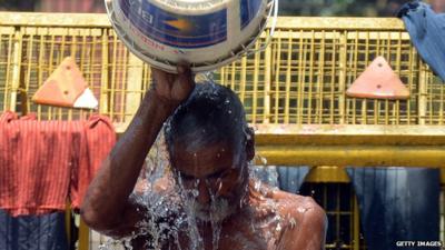 Indian man takes a bath