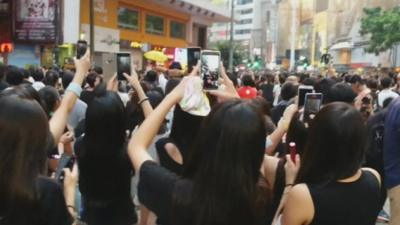 Hong Kong protesters filming sing-along with their mobile phones