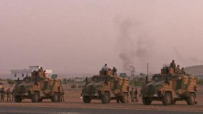 Turkish tanks face away from Syria border town Kobane