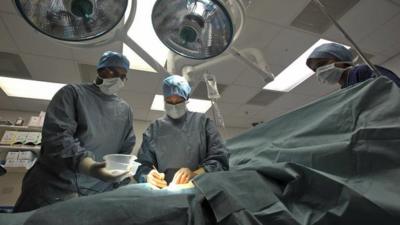 Surgeons working in an operating theatre