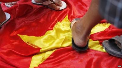 Feet standing on Vietnamese flag