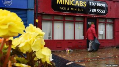 Flowers outside the taxi office where Mr Henning used to work