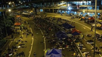 Pro-democracy protestors sleep on streets outside Hong Kong Government complex