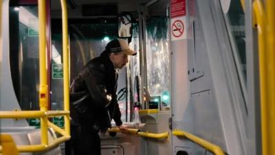 A man paying to get on the nightbus